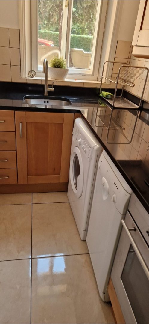 Clean kitchen with a shiny tiled floor after a deep clean in a Dublin home