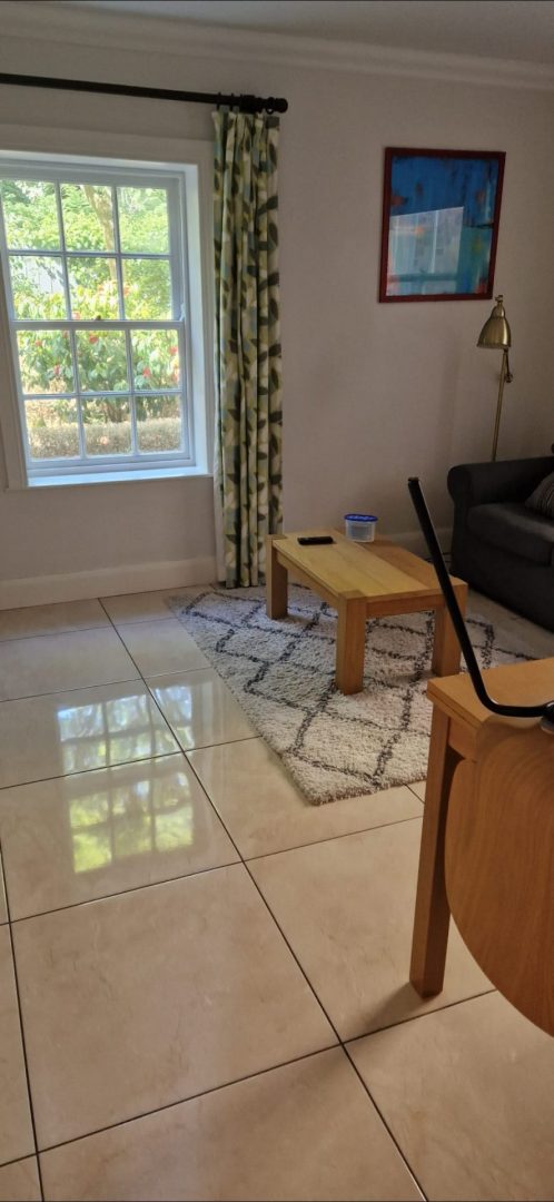 Home and office cleaning in Dublin: a bright living room with a shiny tiled floor