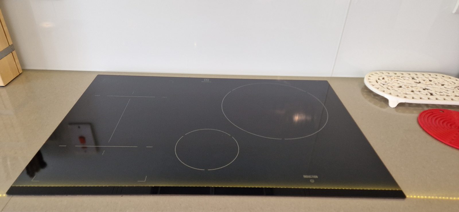 Clean black induction hob after a deep clean with the oven added