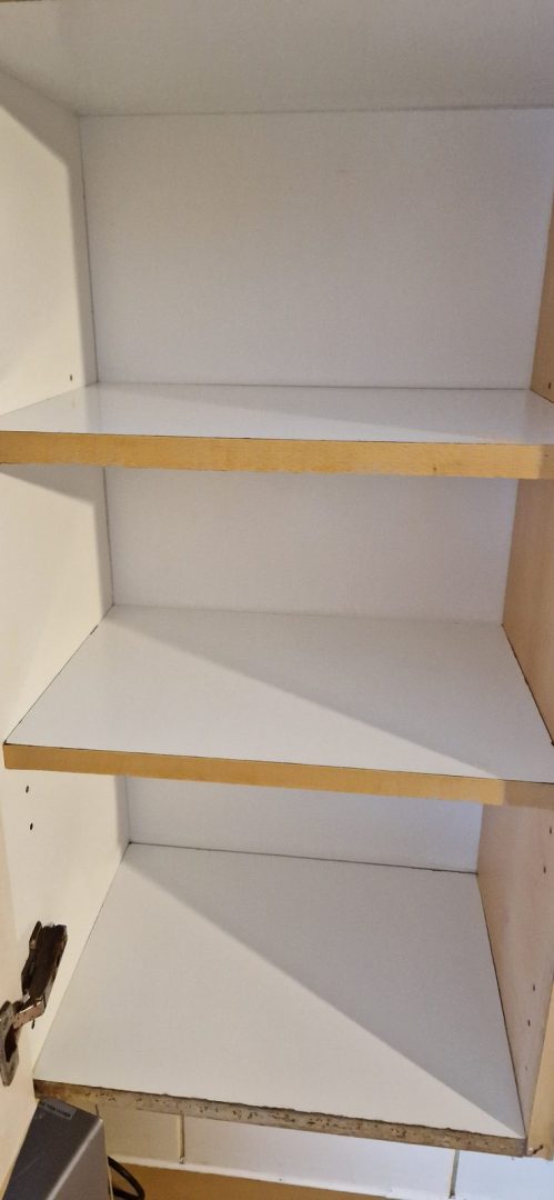 Kitchen cupboard shelves wiped clean inside after an after builders clean