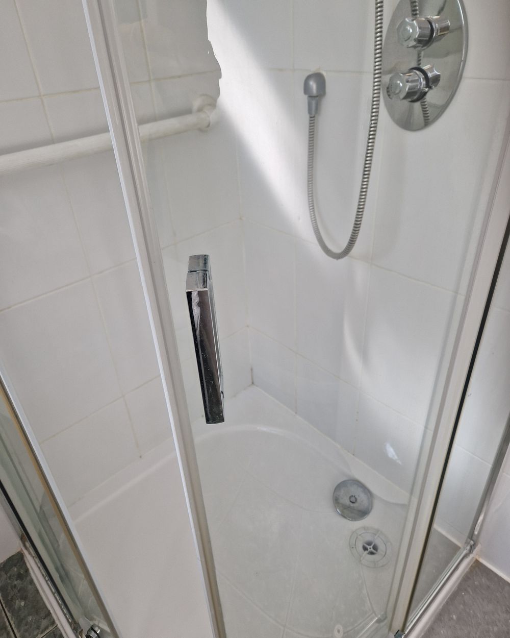 The same shower enclosure after a bathroom deep clean in Dublin, with clear glass and a clean tray